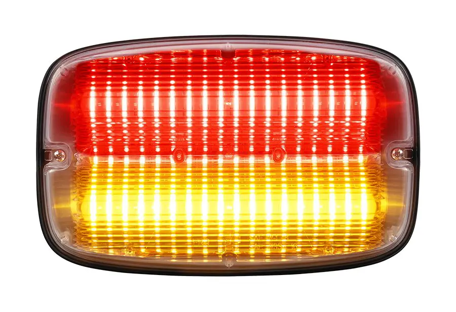 An illuminated red and yellow LED vehicle tail light against a white background.