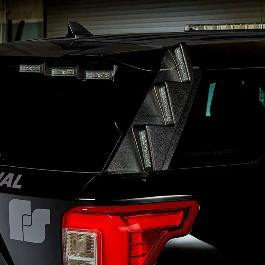 Close-up of a black vehicle's rear section with multiple rectangular lights mounted above and on the side of the back window.