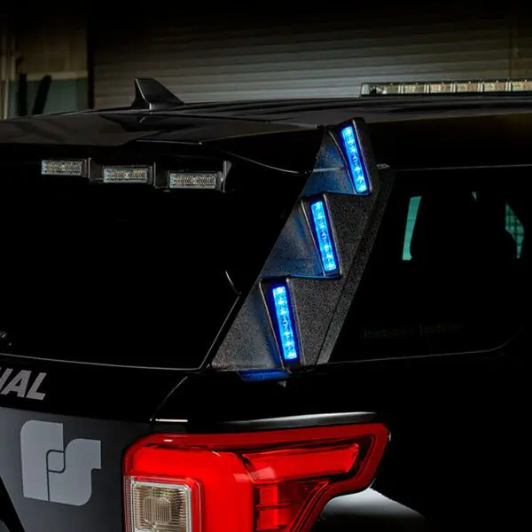 A close-up of a police vehicle showing blue emergency lights on the back.