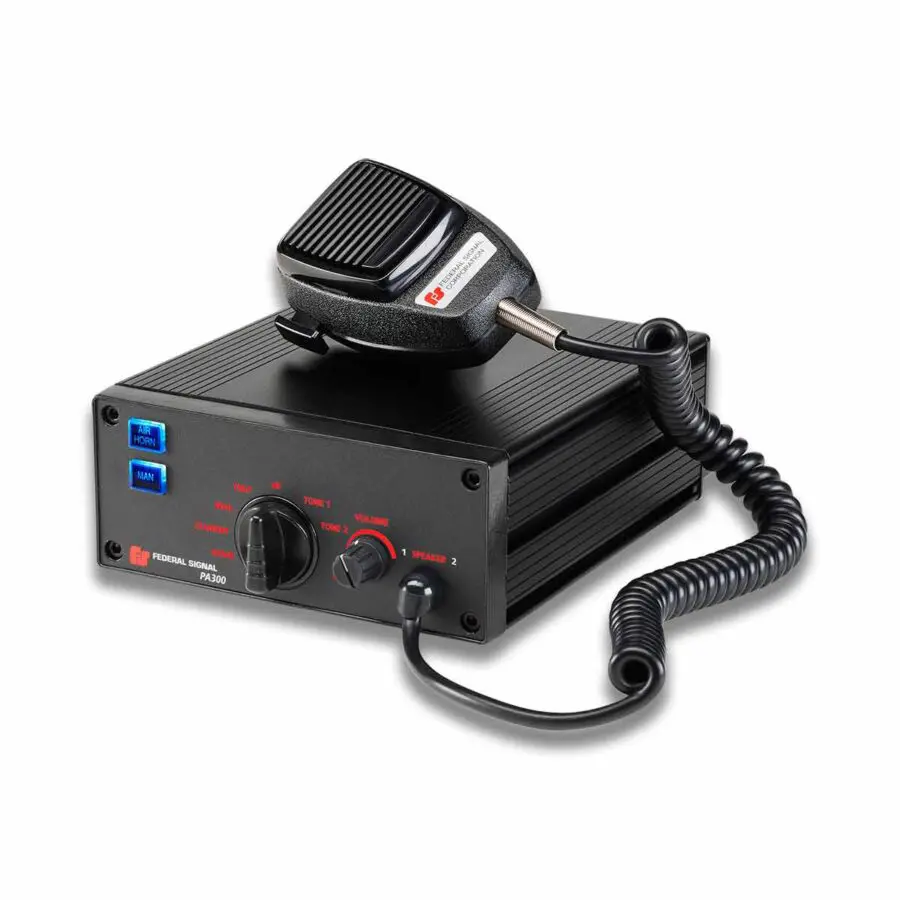 A black CB radio with a coiled microphone on top, featuring various knobs and buttons on its front panel.