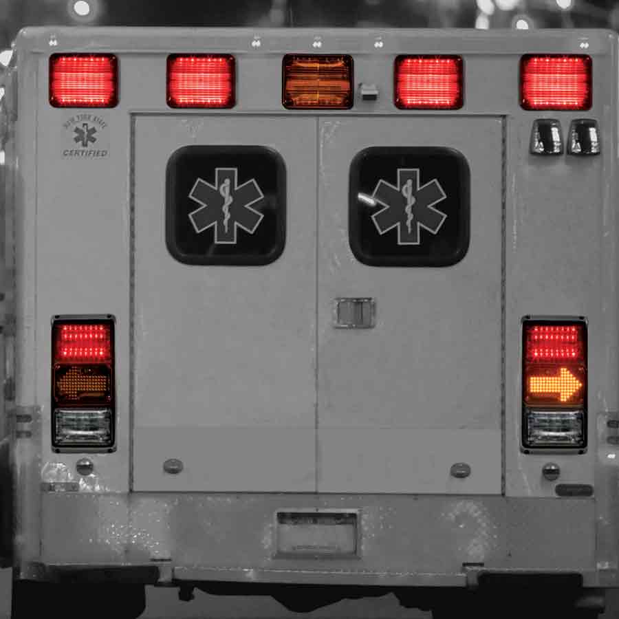 Ambulance with rear QuadraFlare® LED lights, including brake, tail, and turn signals.